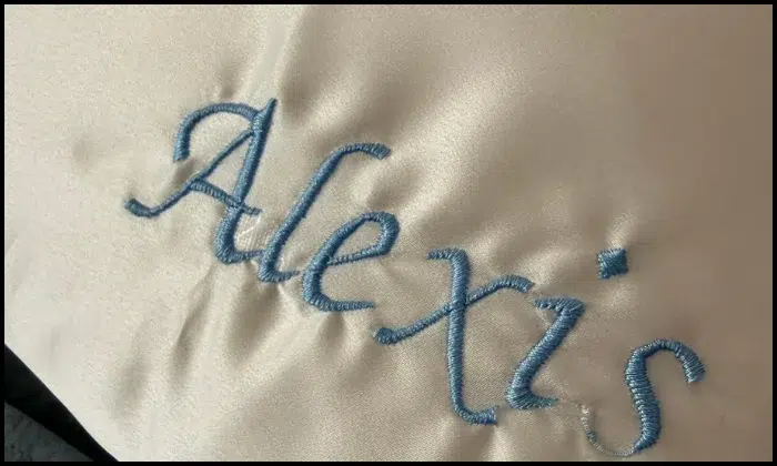 Poor embroidery digitizing causing puckered fabric and uneven text Poor embroidery digitizing causing puckered fabric and uneven text