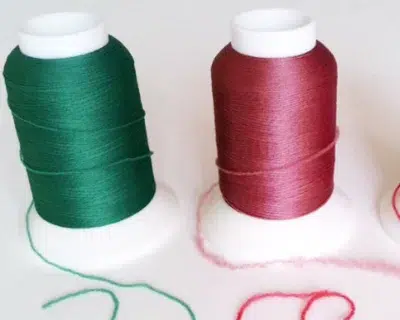 Woolly embroidery thread spools in green and pink color