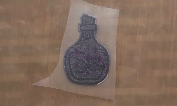 Adding heat seal adhesive to an embroidered patch Adding heat seal adhesive to an embroidered patch
